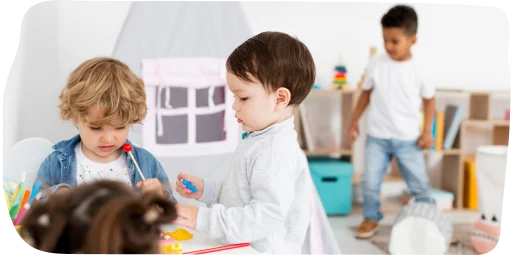 Children participating in active learning activities at Step By Step Nursery in Dubailand, exploring creativity and teamwork with engaging materials.