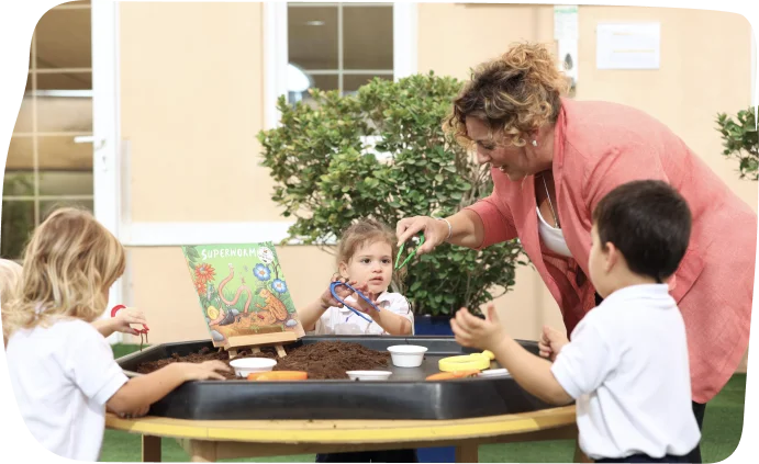 Nursery-aged children exploring sand play with tools and engaging in sensory activities at Step By Step Nursery Dubai.